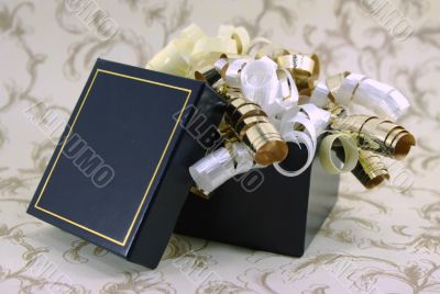 Open Blue and Gold Gift Box with Curly Ribbons