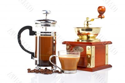 Cup, grinder, coffee pot and beans