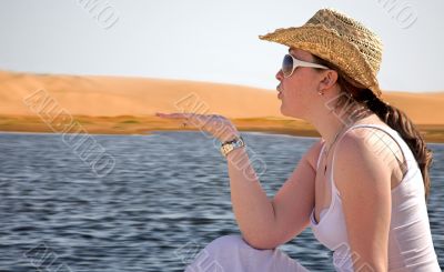 girl displaying product by the beach