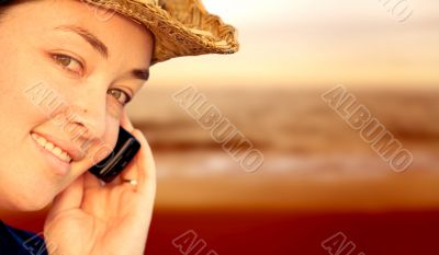 Girl on mobile phone by the beach
