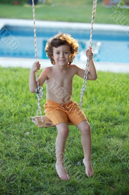 child  playing in a swing
