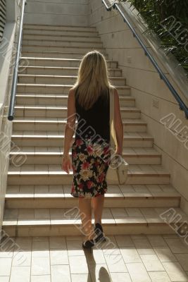 Blonde girl walking on stairs