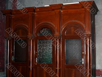 Confession booth lit from the stained glass window Confession booth lit from the stained glass window