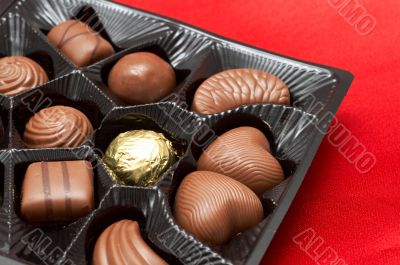 Valentines chocolates in box on red silk