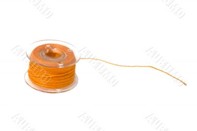 spool of vivid orange thread