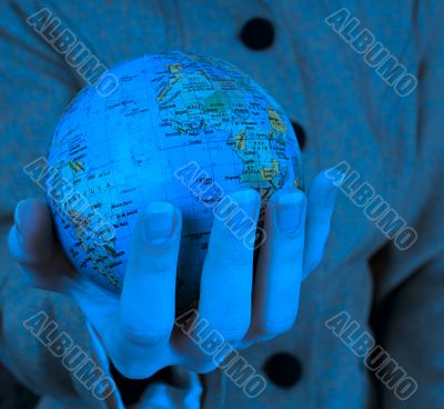 Globe in a girl`s hands