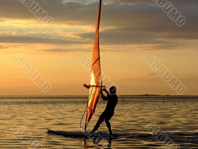 Silhouette of a wind-surfer on waves of a gulf 2