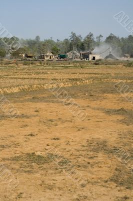 open field with view on stone industry,  india