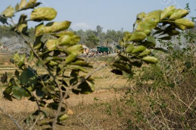 open field with view on stone industry,  india