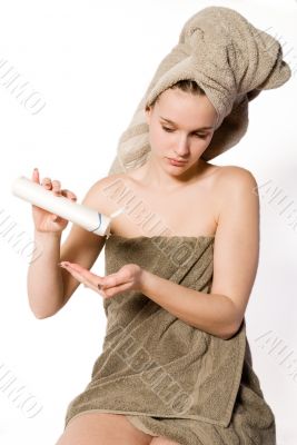 Woman is getting some creme on her hand Woman is getting some creme on her hand