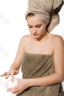 Young woman appying some creme Young woman appying some creme