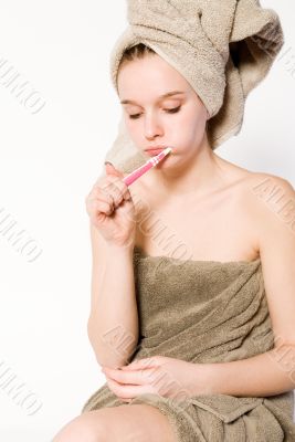 Young woman is brushing her teeth