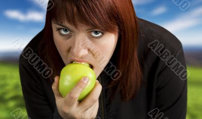 Girl eating delicious green apple