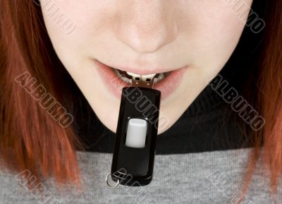Girl biting a flash drive