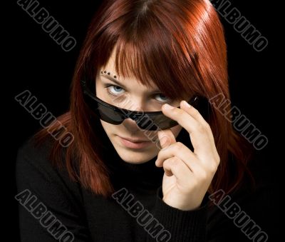 Girl with sunglasses staring at camera Girl with sunglasses staring at camera