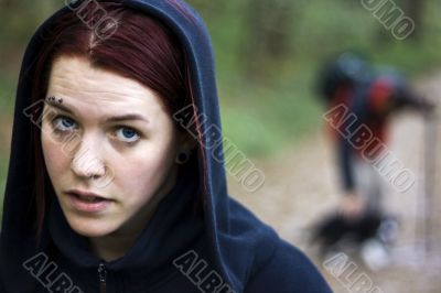 Thirsty girl hiking with a man and his dog in the background