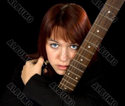 Redhead girl holding her guitar Redhead girl holding her guitar