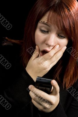 Girl amazed after checking her mobile phone