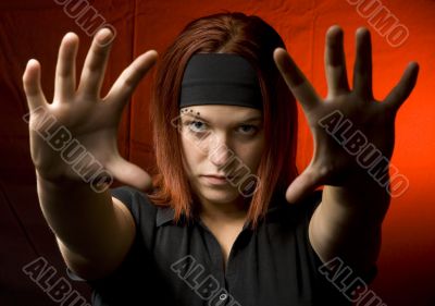 Teenager with her hands against the camera
