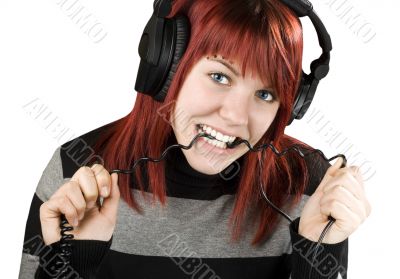 Girl biting headphone cable