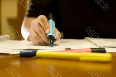 Close-up of a student using the marker pen Close-up of a student using the marker pen