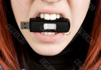Girl biting an usb flash drive