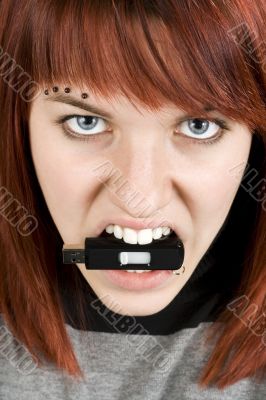 Aggresive girl biting memory stick