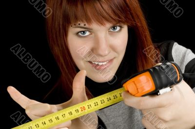 Redhead girl with measuring tool ruler
