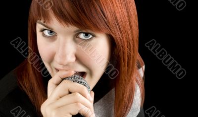 Girl singing karaoke on microphone