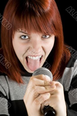 Redhead girl screaming in microphone