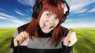 Girl biting headphone cable