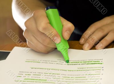 Student using marker to mark important text