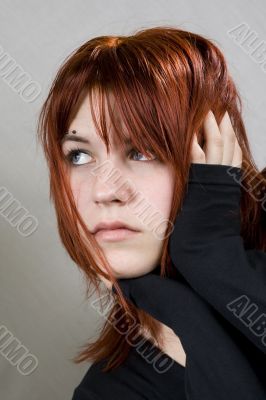 Cute redhead with messy hair looking away
