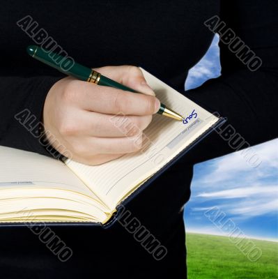 Hand writing down a note saying sold