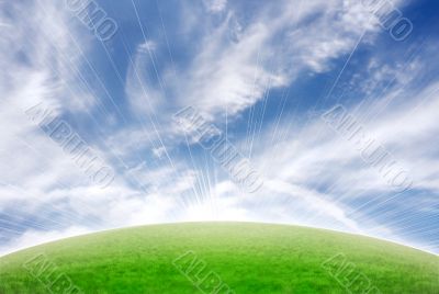 Beautiful meadow with vivid natural sky and sun flare