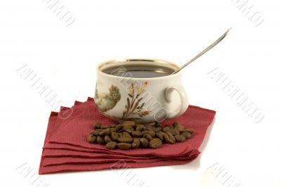 Cup of coffee on red paper with coffee-beans