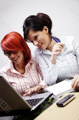 Two businesswomen are working in the office