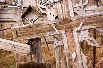 Broken Jesus figure on an old cross