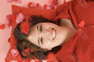 young beautiful woman laying on a red pillow
