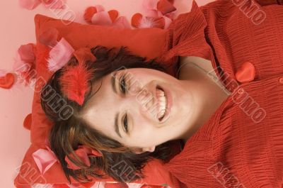 young beautiful woman laying on a red pillow young beautiful woman laying on a red pillow