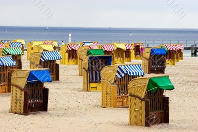 Beach wicker chairs near sea