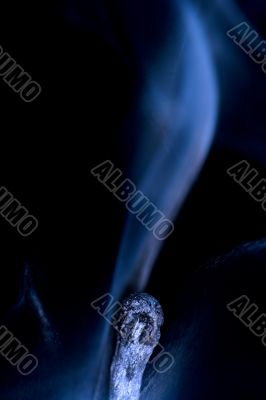 Match with smoke isolated in dark background