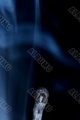 Match with smoke isolated in dark background