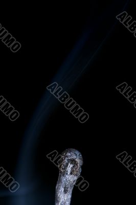 Match with smoke isolated in dark background