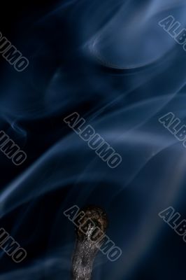 Match with smoke isolated in dark background