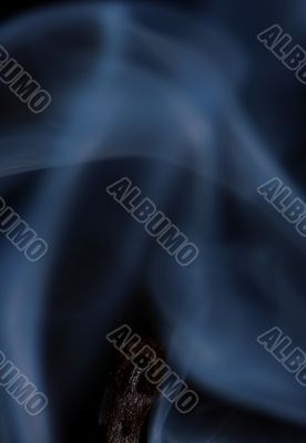 Match with smoke isolated in dark background