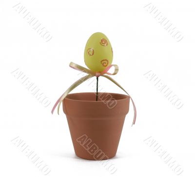 Isolated Yellow Easter Egg in Flower Pot