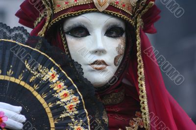 Female mask in a red suit.