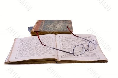 The open ancient book with glasses