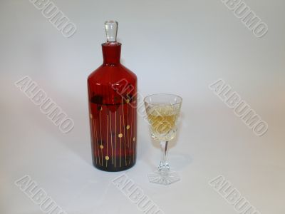 Carafe with a brandy and the filled wineglass